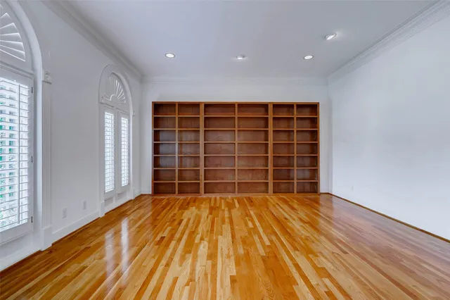 a view of empty room with a wooden floor and windows
