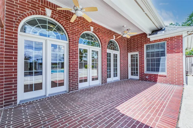 a view of a brick house with large windows