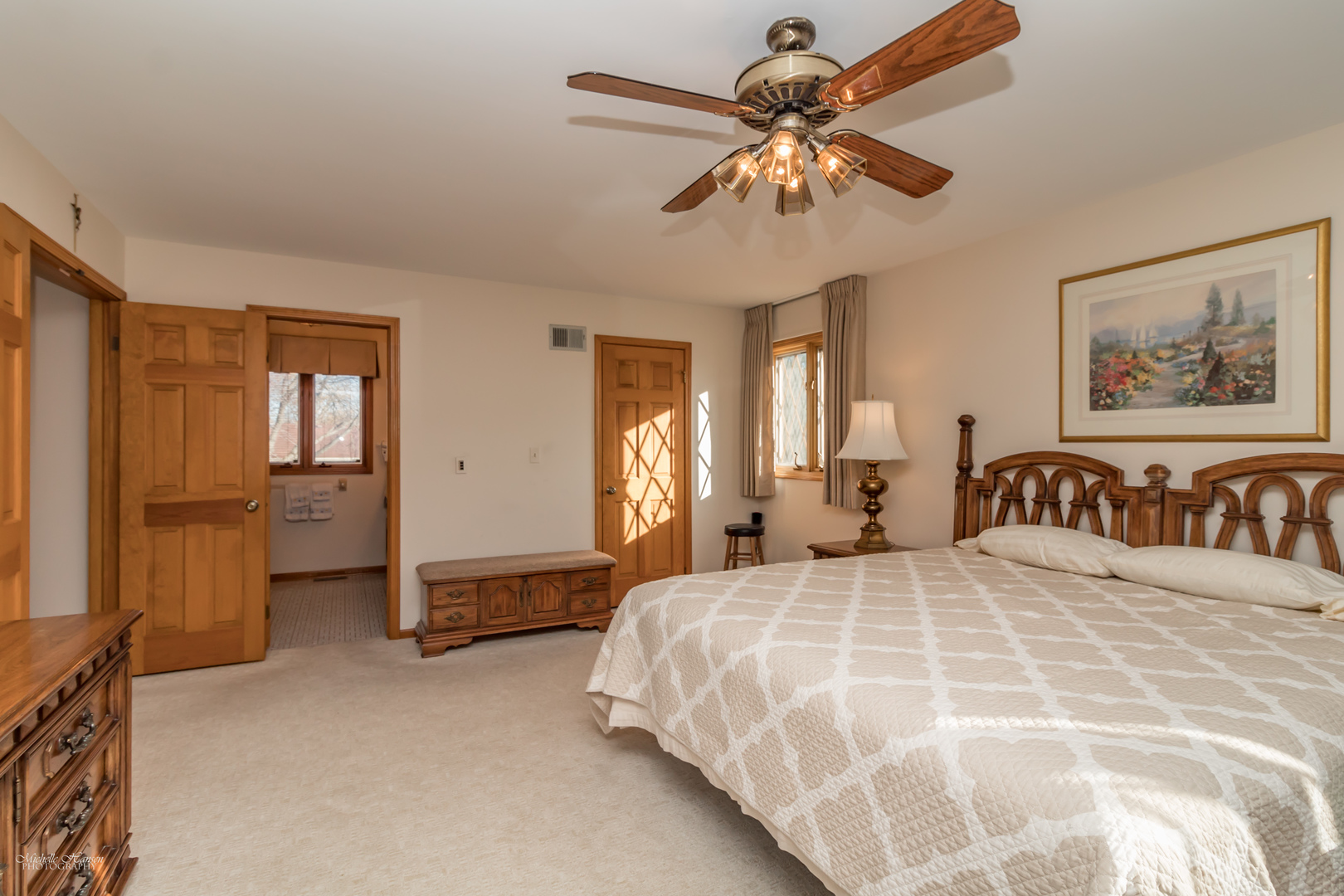2203 North Ridge Avenue Arlington Heights, IL 60004 - Photo 16 of 23 a bedroom with a large bed and a chandelier
