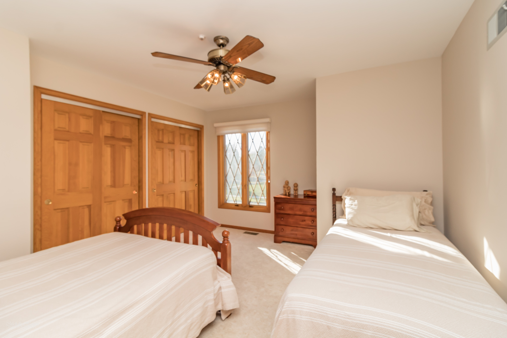 2203 North Ridge Avenue Arlington Heights, IL 60004 - Photo 17 of 23 a bedroom with a large bed and a chandelier