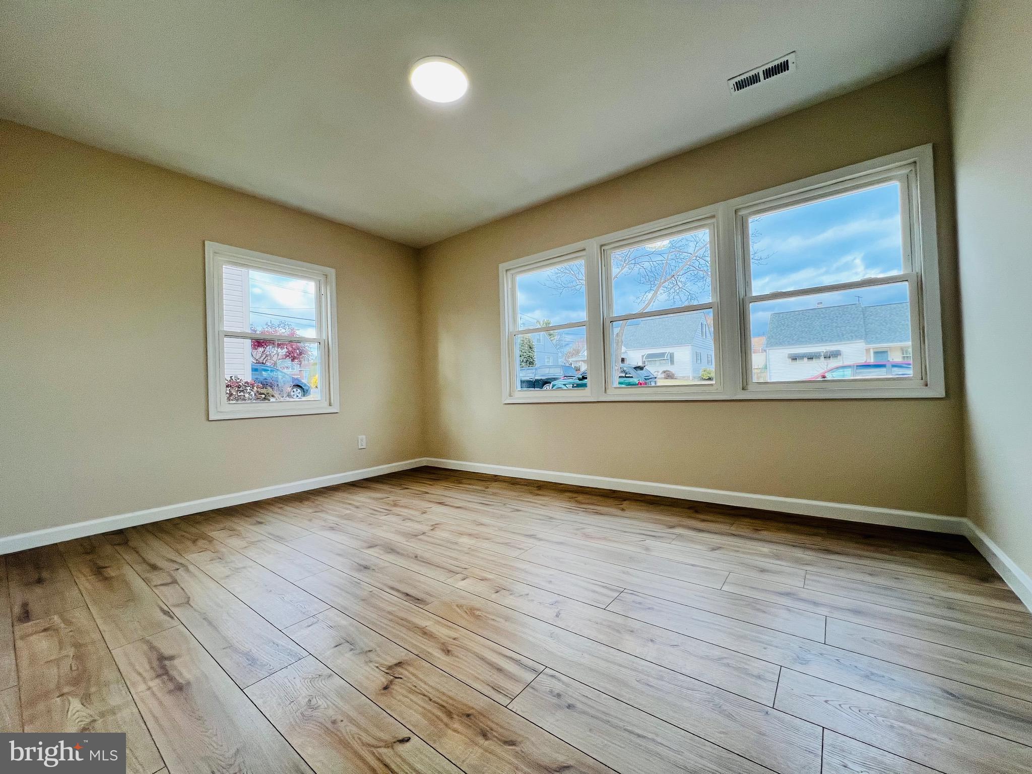 504 Selma Street Philadelphia, PA 19116 - Photo 15 of 31 an empty room with wooden floor and windows