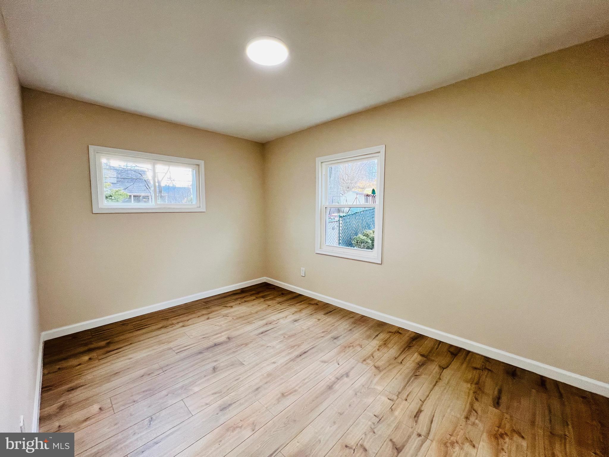 504 Selma Street Philadelphia, PA 19116 - Photo 17 of 31 an empty room with wooden floor and windows