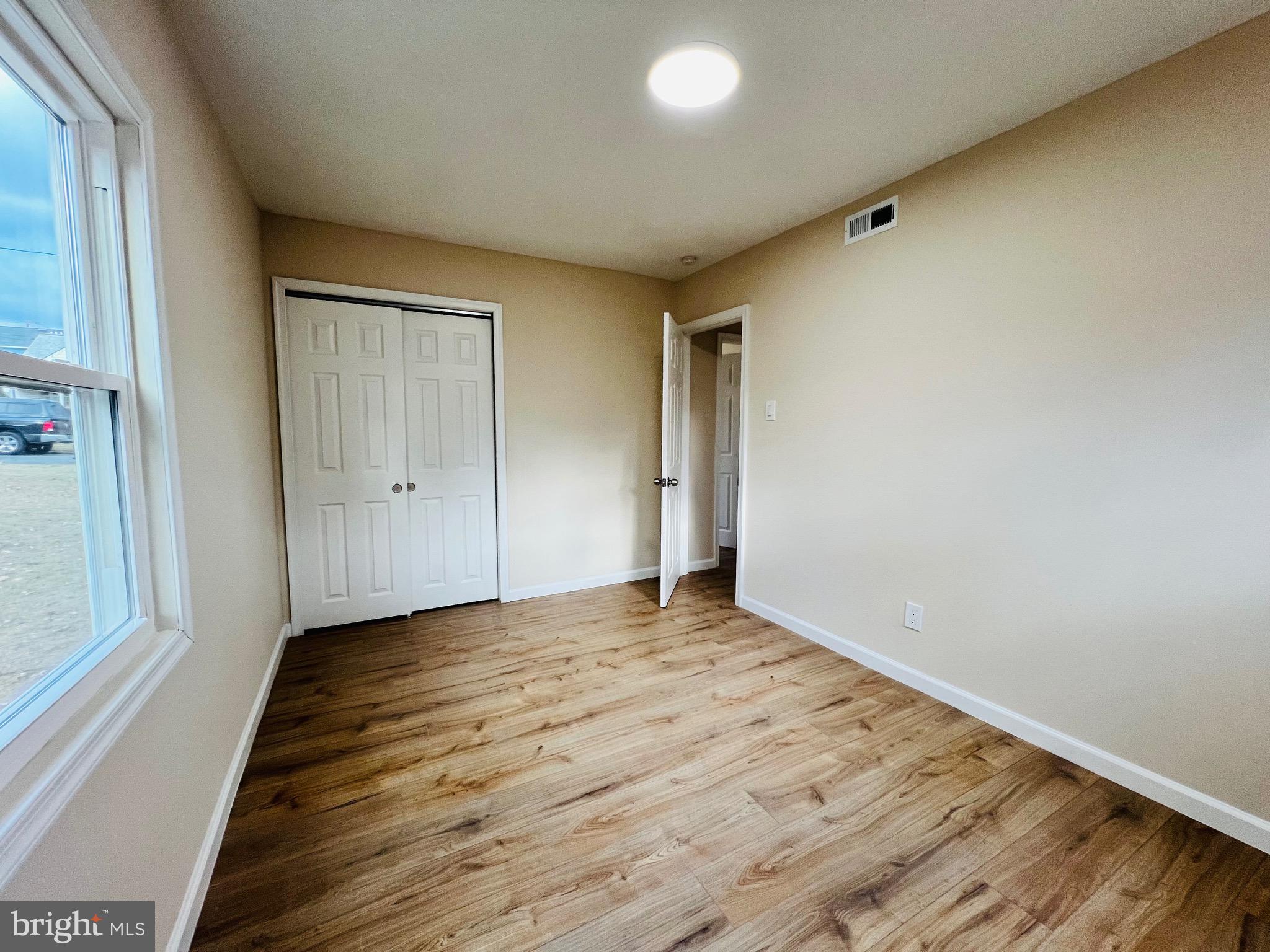 504 Selma Street Philadelphia, PA 19116 - Photo 18 of 31 a view of an empty room with wooden floor and a window