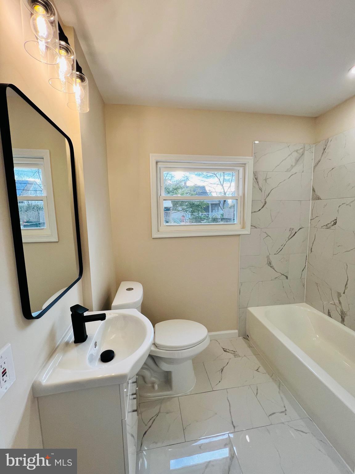 504 Selma Street Philadelphia, PA 19116 - Photo 19 of 31 a bathroom with a toilet sink and mirror