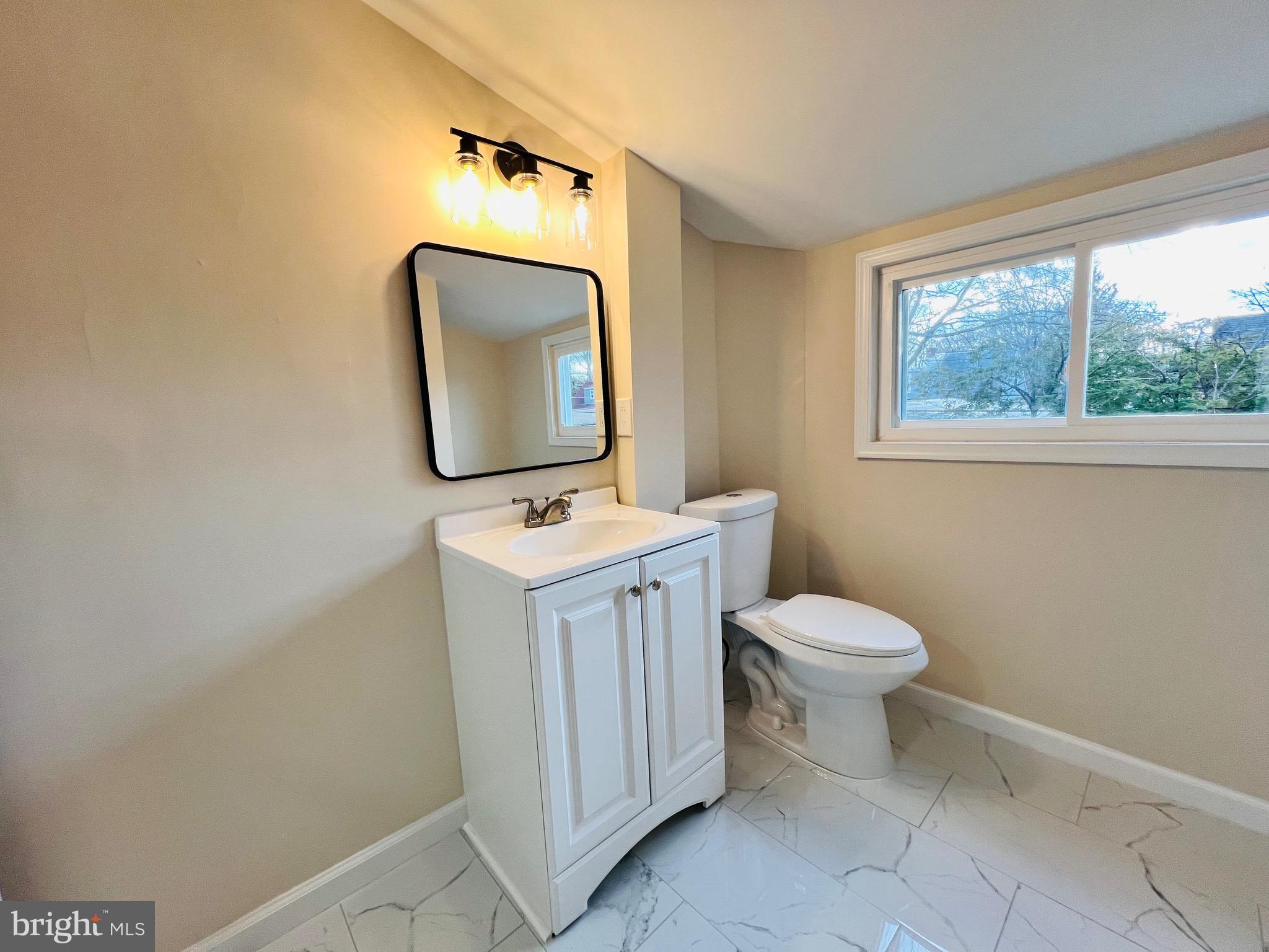 504 Selma Street Philadelphia, PA 19116 - Photo 27 of 31 a bathroom with a toilet sink and mirror