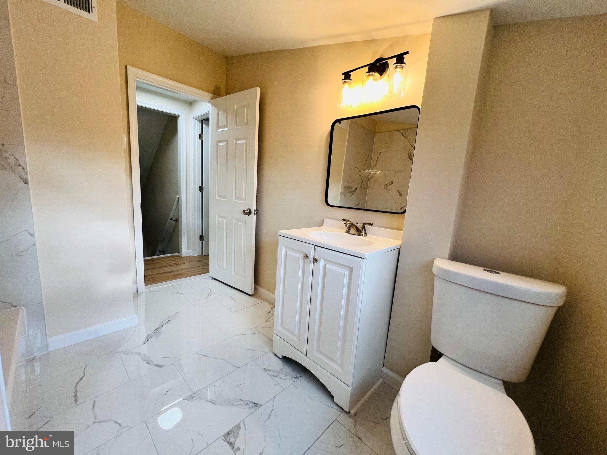 504 Selma Street Philadelphia, PA 19116 - Photo 28 of 31 a bathroom with a toilet sink and mirror