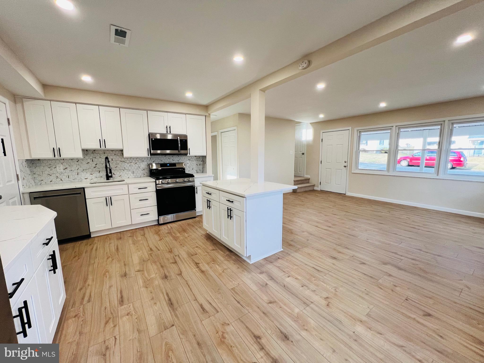 504 Selma Street Philadelphia, PA 19116 - Photo 10 of 31 a large kitchen with stainless steel appliances granite countertop a stove and a refrigerator