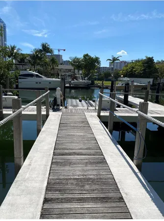a view of a balcony with wooden floor and lake view