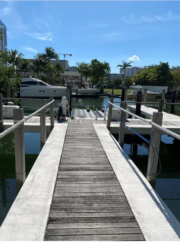 a view of a balcony with wooden floor and lake view