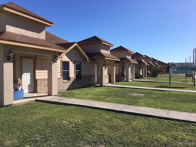 401 Rockport Street Alton, TX 78573 - Photo 1 of 11 View of front of property with a front lawn, brick siding, and stucco siding