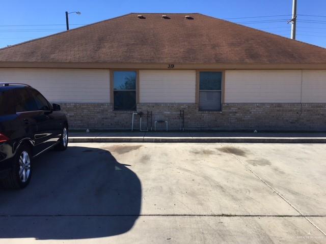 401 Rockport Street Alton, TX 78573 - Photo 4 of 11 View of property exterior with roof with shingles and brick siding