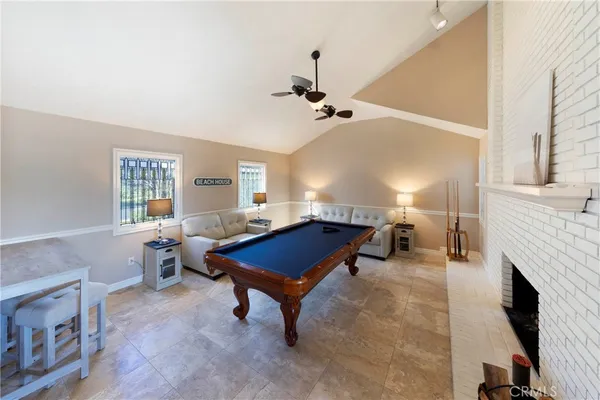 a living room with furniture a fireplace and a window