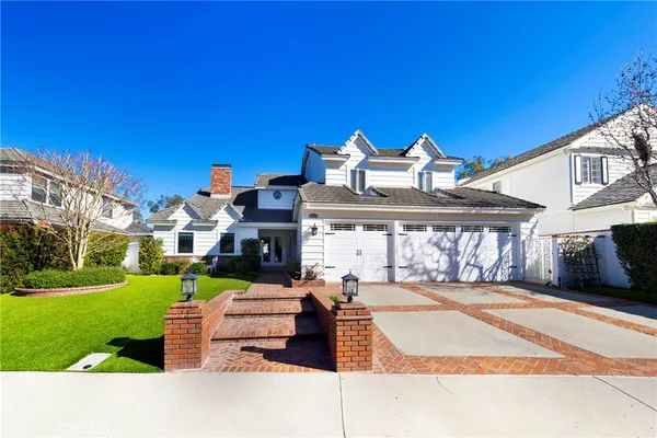 a front view of a house with a garden and yard