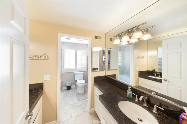 a bathroom with a sink double vanity and a mirror