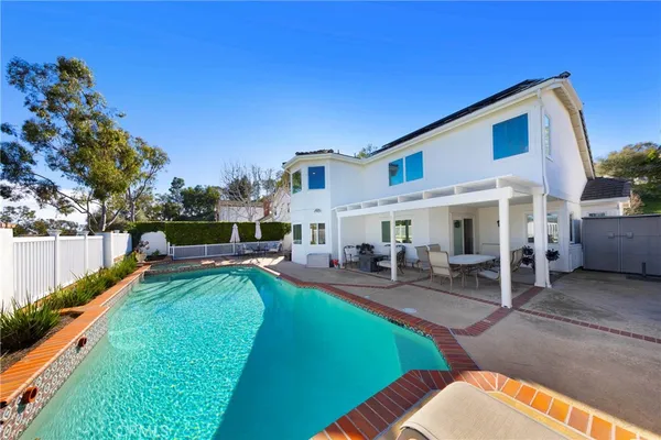 a view of a house with backyard porch and sitting area