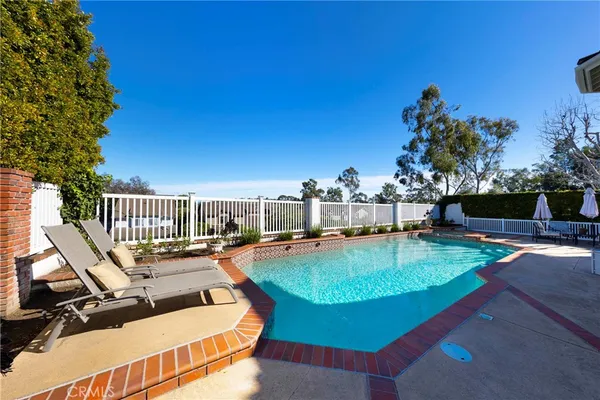 a view of a swimming pool with lounge chairs