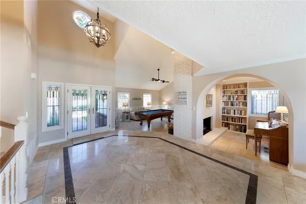 a living room with fireplace furniture and a large window