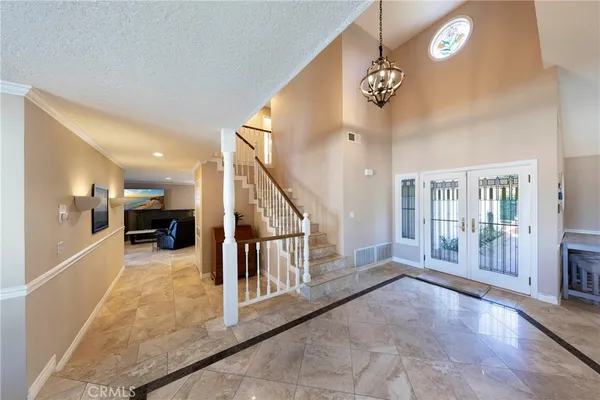 a view of a hallway with entryway and livingroom view