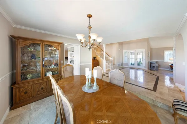 a living room with fireplace furniture and a chandelier