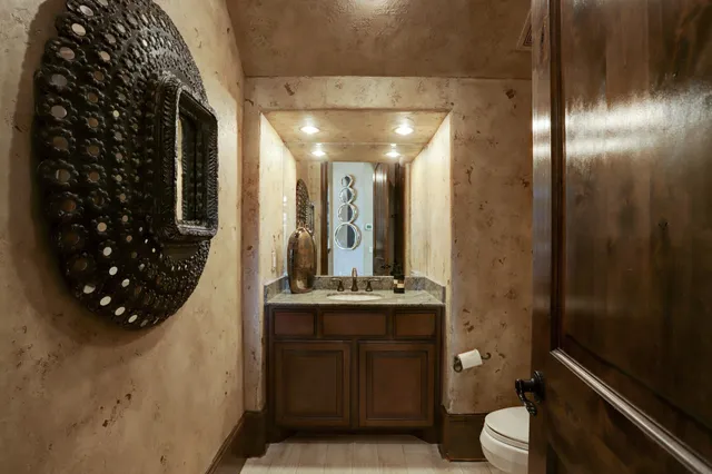 a bathroom with a toilet sink and mirror