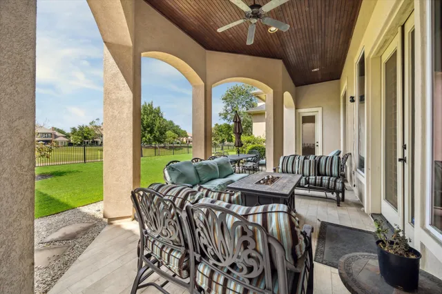 a balcony with furniture and a potted plant