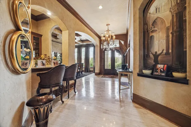a view of a entryway with furniture and chandelier