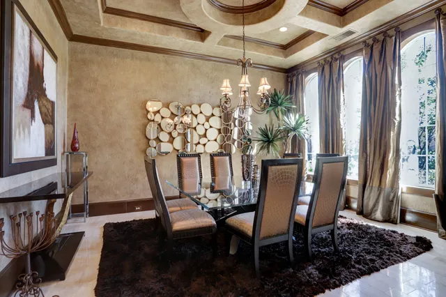 a view of a dining room with furniture and a window