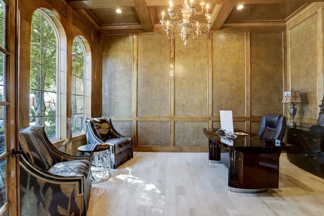 a living room with furniture and floor to ceiling windows