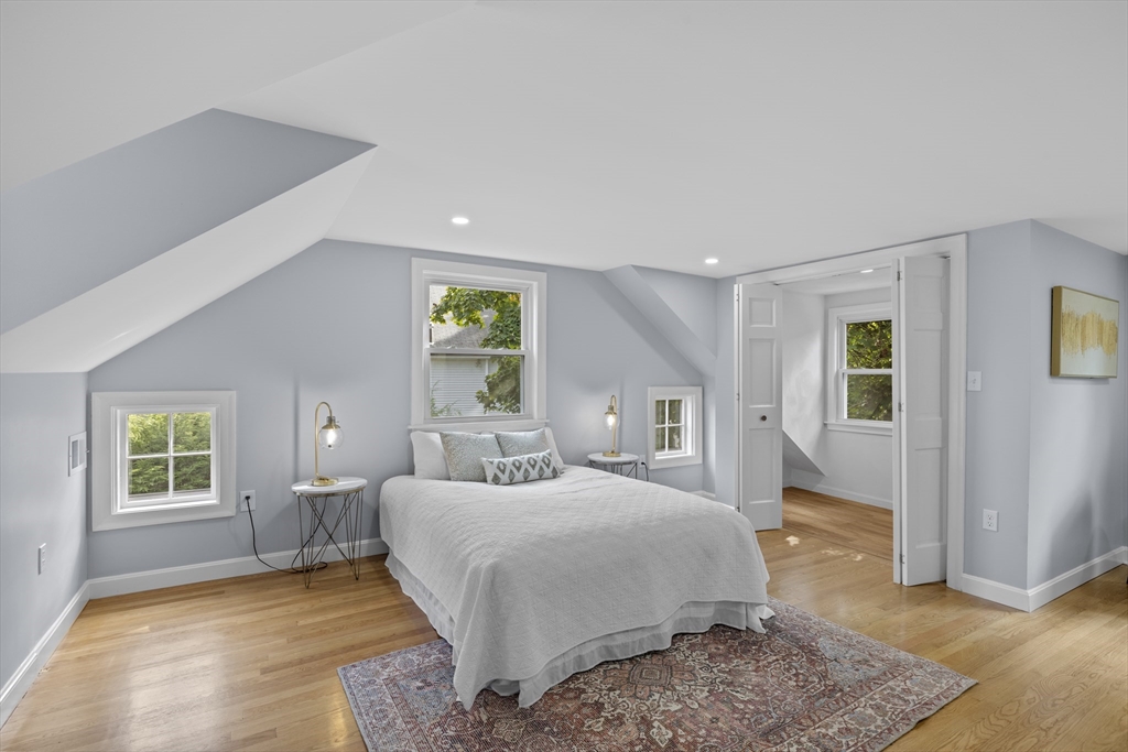108 Radcliffe Road Belmont, MA 02478 - Photo 22 of 39 a bedroom with a large bed rug and wooden floor