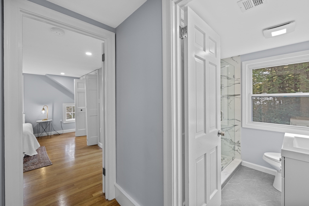 108 Radcliffe Road Belmont, MA 02478 - Photo 28 of 39 a view of a hallway with wooden floor and a bathroom