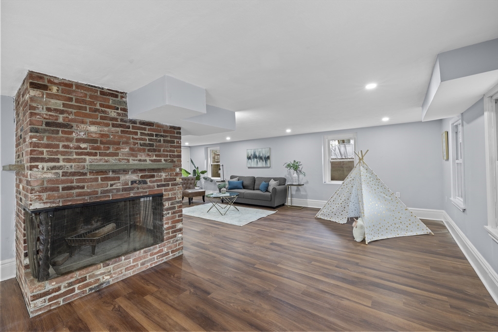 108 Radcliffe Road Belmont, MA 02478 - Photo 33 of 39 a living room with furniture a fireplace and wooden floor