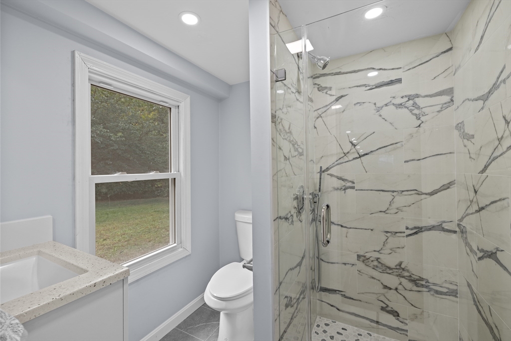 108 Radcliffe Road Belmont, MA 02478 - Photo 35 of 39 a bathroom with a granite countertop sink toilet and shower