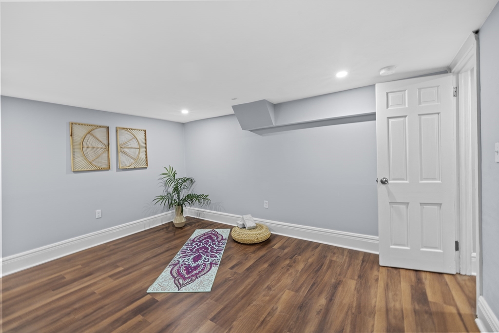 108 Radcliffe Road Belmont, MA 02478 - Photo 36 of 39 a room with wooden floor and glass door