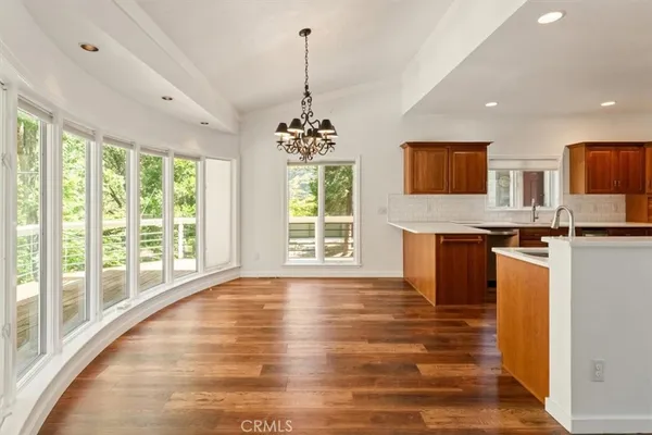 a view of kitchen with granite countertop cabinets and outdoor space