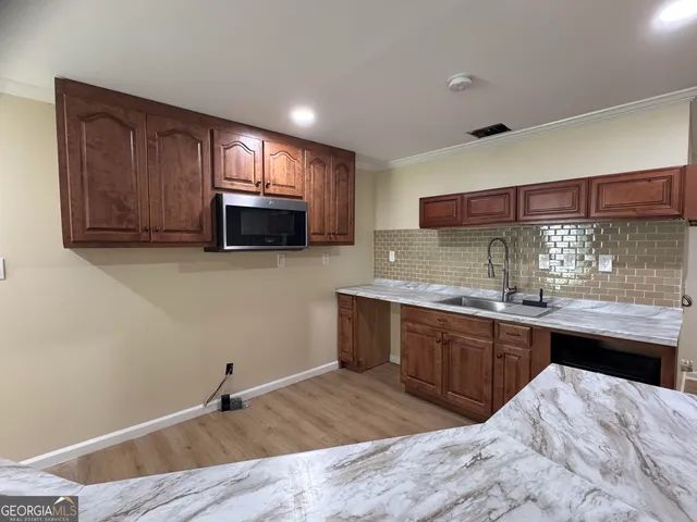 a kitchen with stainless steel appliances granite countertop a sink stove and microwave
