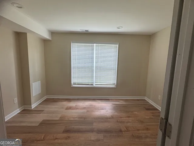 a view of wooden floor and windows in a room