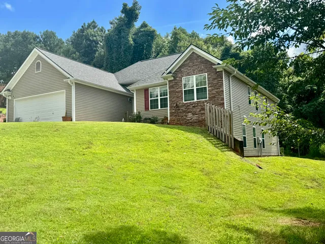 a front view of house with yard and green space