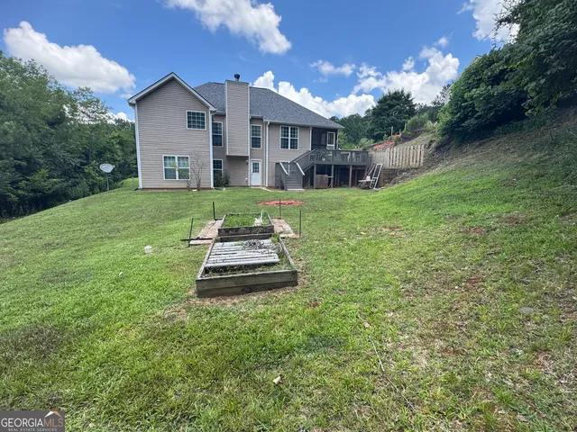 a front view of a house with a yard and green space
