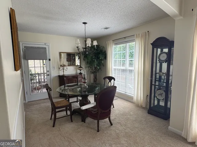 a dining room with furniture and window