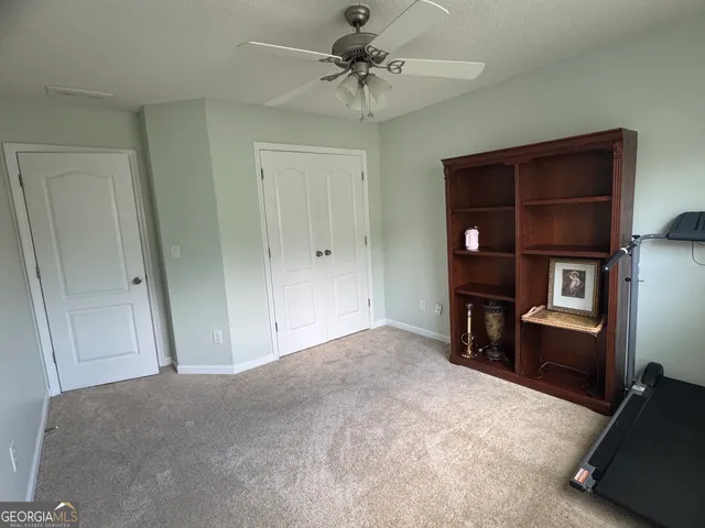 a furnished livingroom with a cabinet and a rug