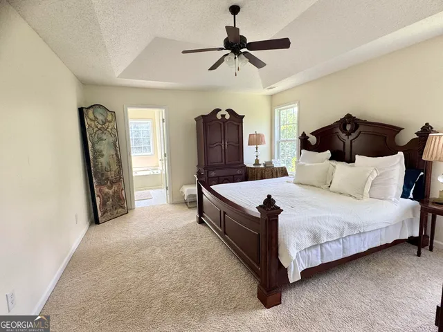 a spacious bedroom with a bed and a walk in closet