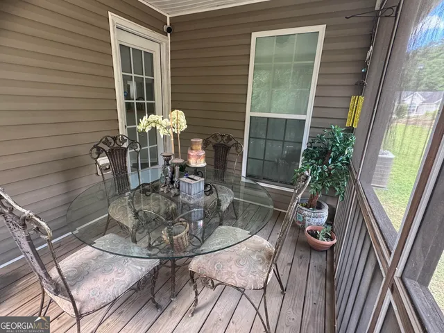 a dining room with furniture and wooden floor