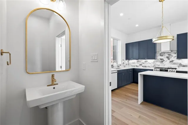 a bathroom with a double vanity sink toilet and a mirror
