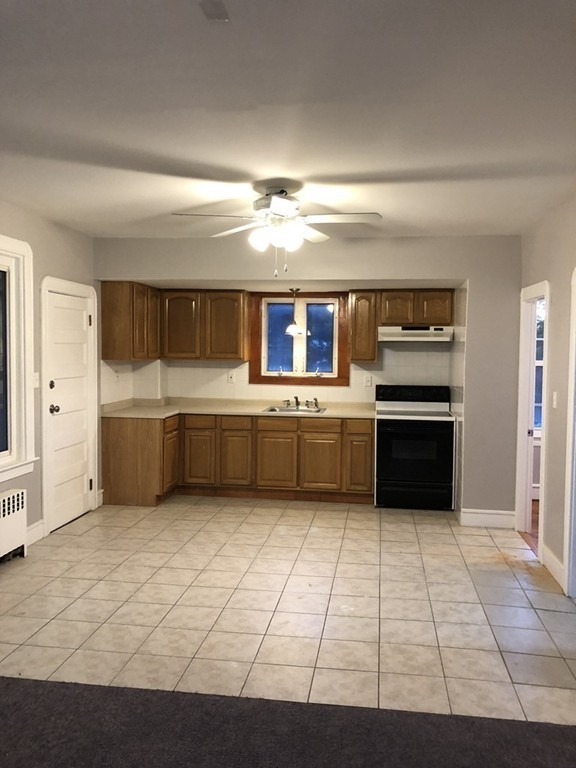 227 Ames Street Fall River, MA 02721 - Photo 11 of 18 a kitchen with a cabinets and white stainless steel appliances