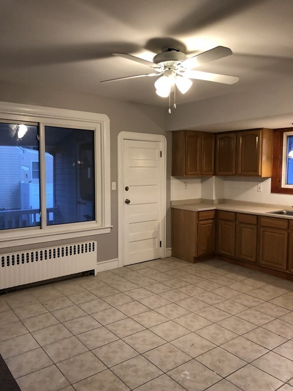 227 Ames Street Fall River, MA 02721 - Photo 13 of 18 a view of a kitchen with a sink cabinets and window