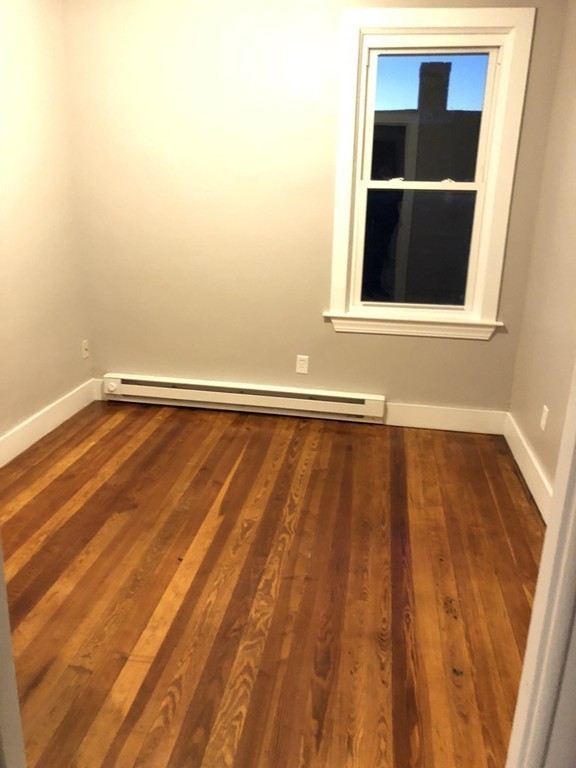 227 Ames Street Fall River, MA 02721 - Photo 14 of 18 a view of an empty room with wooden floor and a window