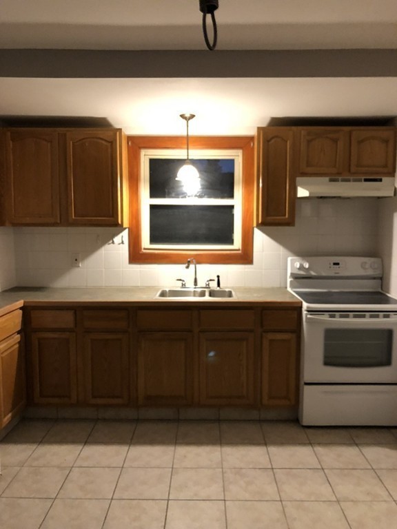 227 Ames Street Fall River, MA 02721 - Photo 17 of 18 a kitchen with a sink and cabinets