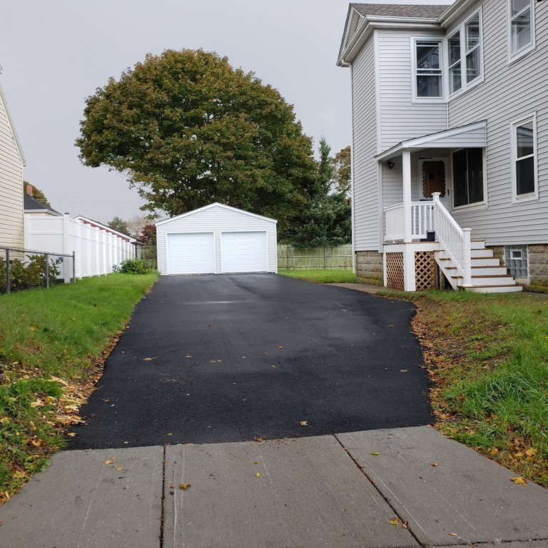 227 Ames Street Fall River, MA 02721 - Photo 2 of 18 a front view of a house with a yard and garage