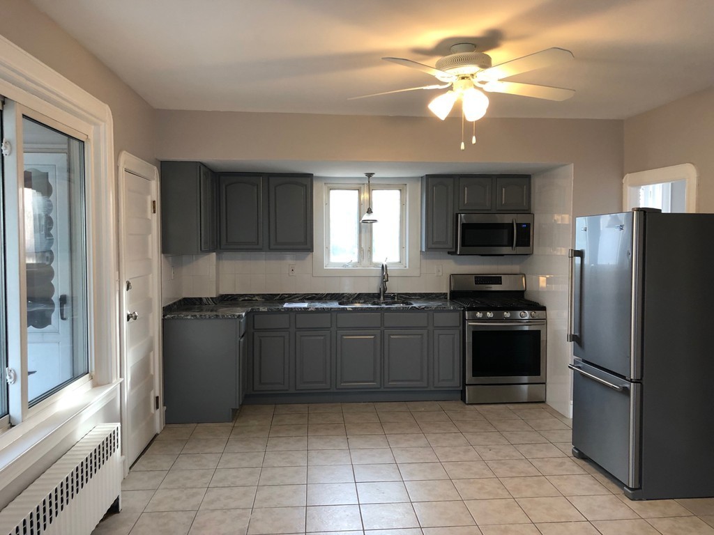 227 Ames Street Fall River, MA 02721 - Photo 3 of 18 a kitchen with stainless steel appliances granite countertop a refrigerator oven a sink dishwasher and a refrigerator