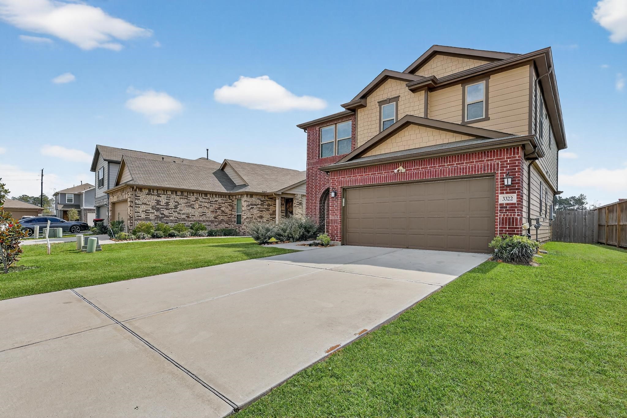 3322 Nila Creek Dr Spring Spring, TX 77373 - Photo 2 of 36 Alternate exterior angle highlighting the home’s curb appeal, wide driveway, and well-maintained front yard.
